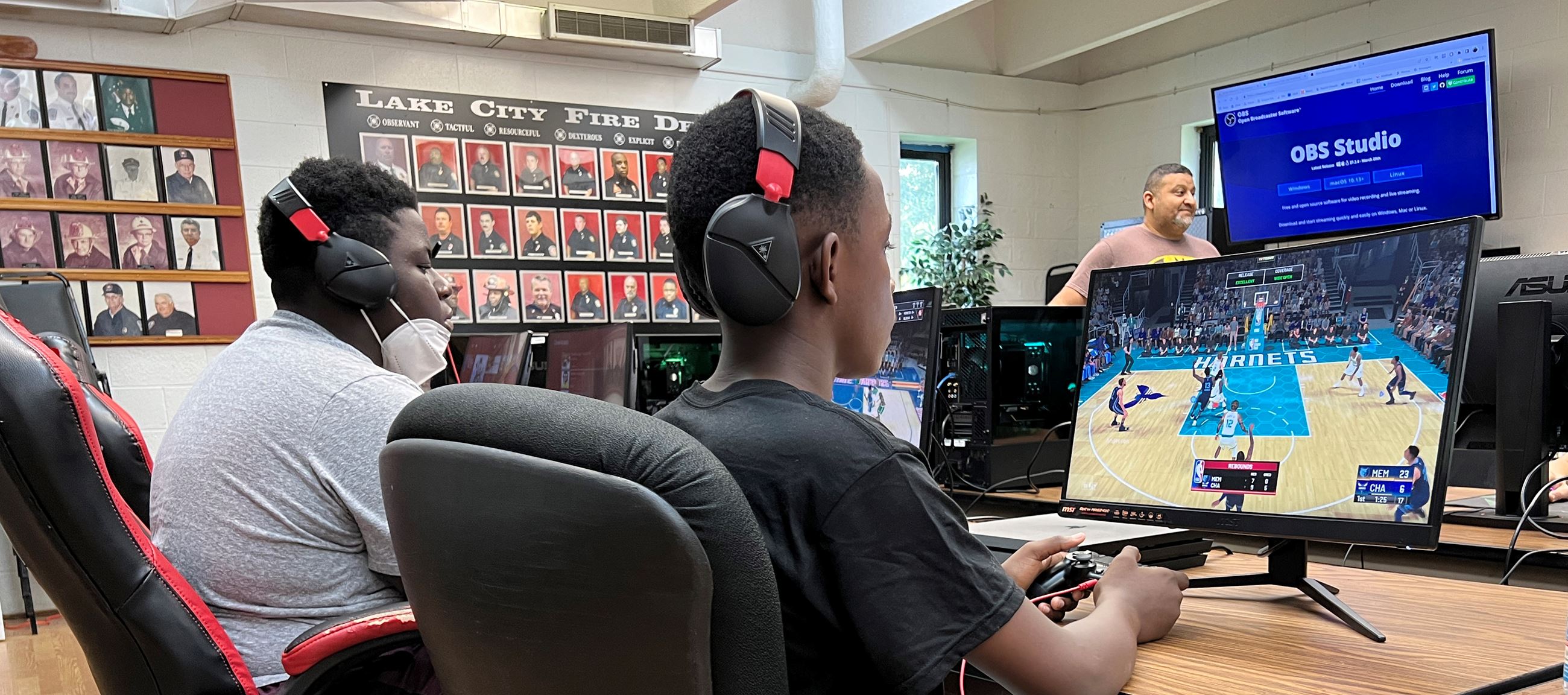Lake City Esports Camp 2022. Two students compete on a streamed sports game.