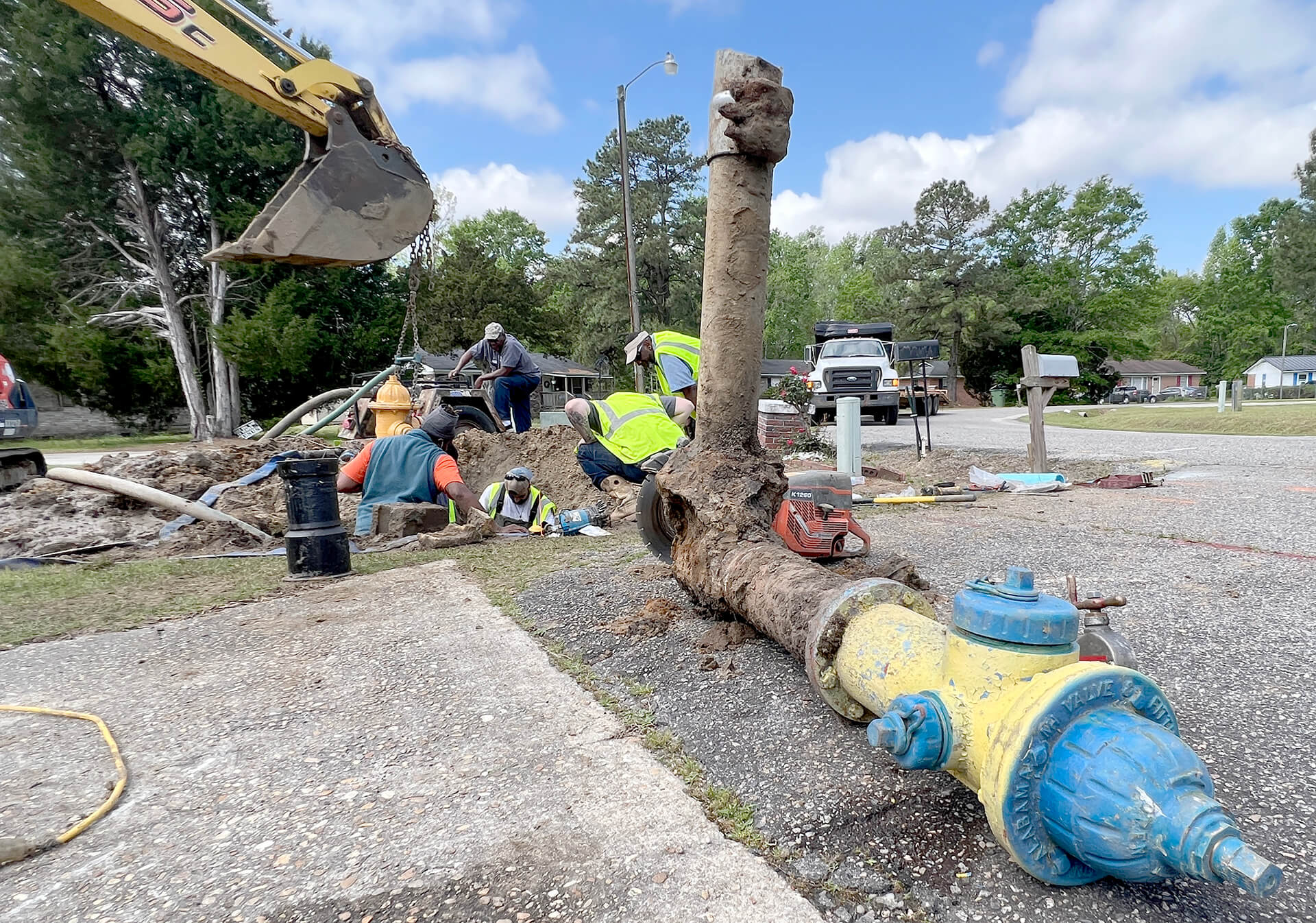 Lake City line maintenance crew members remove a damaged 1960s fire hydrant on Palm Circle on April 